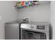 Laundry room features modern washer and dryer along with wire shelving at 6728 Great Bear Dr, Lakeland, FL 33805