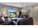 Bright living room features a cozy fireplace, lake views, and sliding glass doors to the patio at 6728 Great Bear Dr, Lakeland, FL 33805