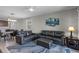 Stylish living room features comfortable dark leather furniture, plush rug, and an open view of the kitchen at 6728 Great Bear Dr, Lakeland, FL 33805