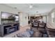 Open-concept living room with fireplace, tile flooring, and a view of the kitchen and dining area at 6728 Great Bear Dr, Lakeland, FL 33805