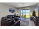 Bright living room features an oversized rug, comfortable seating, and sliding doors leading to a patio at 6728 Great Bear Dr, Lakeland, FL 33805