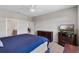 Spacious main bedroom with ceiling fan, dark wood furnishings and ensuite bathroom at 6728 Great Bear Dr, Lakeland, FL 33805