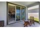 A cozy patio features a table and chairs with a view of the interior and lake at 6728 Great Bear Dr, Lakeland, FL 33805