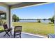 A charming patio features an outdoor table with picturesque lake views at 6728 Great Bear Dr, Lakeland, FL 33805