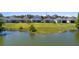 Beautifully landscaped backyard leading down to a serene lake, perfect for relaxation at 6728 Great Bear Dr, Lakeland, FL 33805