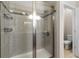 Shower with glass door, bench, and tiled surround at 6728 Great Bear Dr, Lakeland, FL 33805