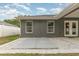 Exterior of the home featuring a small patio and a yard with gravel at 7101 Se 124Th St, Belleview, FL 34420