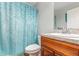 Bathroom featuring a vanity with faux marble countertop and a blue patterned shower curtain at 7101 Se 124Th St, Belleview, FL 34420