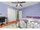 Bedroom featuring ceiling fan, office chair and desk, and large closet for plenty of storage at 7101 Se 124Th St, Belleview, FL 34420