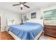 Inviting bedroom featuring a cozy bed, ceiling fan, and bedside tables with lamps for ambient lighting at 7101 Se 124Th St, Belleview, FL 34420