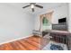 Bright bedroom with hardwood floors, a ceiling fan and natural light from the window at 7101 Se 124Th St, Belleview, FL 34420