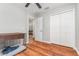 Bedroom featuring wood floors, closet, and an open doorway leading to the living room at 7101 Se 124Th St, Belleview, FL 34420