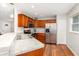 Well-lit kitchen with stainless steel appliances, wood cabinets, and a breakfast bar at 7101 Se 124Th St, Belleview, FL 34420