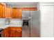 Kitchen boasts stainless steel refrigerator, granite countertops, and wooden cabinets for a modern aesthetic at 7101 Se 124Th St, Belleview, FL 34420