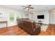 Cozy living room featuring hardwood floors, a ceiling fan, and a comfortable recliner couch at 7101 Se 124Th St, Belleview, FL 34420
