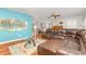 Bright living room area with hardwood floors, a modern coffee table, and a stylish blue accent wall at 7101 Se 124Th St, Belleview, FL 34420
