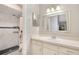 Updated bathroom featuring a tile shower with a black and white accent and vanity with lots of storage at 720 Lakeside Dr, Winter Springs, FL 32708