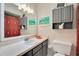Bathroom with gray cabinets, a vanity with plenty of storage, and custom decorations at 720 Lakeside Dr, Winter Springs, FL 32708