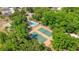 Overhead shot of community amenities: pool, tennis courts surrounded by mature trees and greenery at 720 Lakeside Dr, Winter Springs, FL 32708