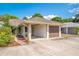 Charming home featuring an attached garage, carport, inviting front yard, and appealing curb appeal at 720 Lakeside Dr, Winter Springs, FL 32708