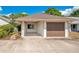 Charming home featuring an attached garage, carport, and inviting front yard landscaping at 720 Lakeside Dr, Winter Springs, FL 32708