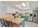 Charming kitchen featuring white cabinets, stainless steel appliances, and a bright skylight at 720 Lakeside Dr, Winter Springs, FL 32708