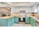Bright kitchen boasts updated stainless steel appliances, wooden countertop, and green cabinets at 720 Lakeside Dr, Winter Springs, FL 32708