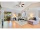 Bright and airy living room featuring vaulted ceilings, ceiling fan, and sliding glass doors to the patio at 720 Lakeside Dr, Winter Springs, FL 32708