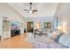 Bright and airy living room featuring vaulted ceilings, ceiling fan, and sliding glass doors to the patio at 720 Lakeside Dr, Winter Springs, FL 32708