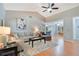 Open living room featuring a sofa, accent chair, ceiling fan and an adjacent dining area at 720 Lakeside Dr, Winter Springs, FL 32708
