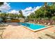 Sparkling community pool surrounded by lounge chairs and lush landscaping at 720 Lakeside Dr, Winter Springs, FL 32708
