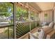 Cozy screened porch with comfortable seating overlooking a beautifully landscaped yard at 720 Lakeside Dr, Winter Springs, FL 32708