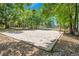 Outdoor sand volleyball court surrounded by mature trees, ideal for recreation at 720 Lakeside Dr, Winter Springs, FL 32708
