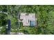 Overhead shot of home with pool in a green landscape, showcasing the roof and surrounding yard at 725 Bear Creek Cir, Winter Springs, FL 32708