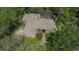 Aerial view of a beautiful brick home with a screened pool surrounded by lush greenery and trees at 725 Bear Creek Cir, Winter Springs, FL 32708