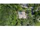 Aerial perspective of a home with a pool enveloped by lush greenery and neighboring properties at 725 Bear Creek Cir, Winter Springs, FL 32708
