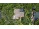 Aerial view of a well-maintained home with a screened pool nestled in a lush, green landscape at 725 Bear Creek Cir, Winter Springs, FL 32708
