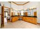 Large bathroom with dual sinks, granite counters, and wood cabinets at 725 Bear Creek Cir, Winter Springs, FL 32708