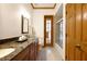 Bathroom featuring double vanity with granite countertops, wood cabinets, and a door to the pool at 725 Bear Creek Cir, Winter Springs, FL 32708