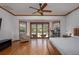 Bright bedroom with wood floors, ceiling fan, and sliding doors to outdoor space at 725 Bear Creek Cir, Winter Springs, FL 32708
