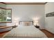 Bright bedroom with wooden floors, soft lighting from bedside lamps, and textured white bedding at 725 Bear Creek Cir, Winter Springs, FL 32708