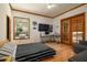 Bedroom with a striped bedspread, wood floors, a large window, and sliding doors leading outside at 725 Bear Creek Cir, Winter Springs, FL 32708