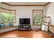 The bedroom features bay windows, a TV, and wood floors at 725 Bear Creek Cir, Winter Springs, FL 32708