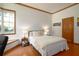 This bedroom features wood trim, a bay window, bedside lamps, and wood floors at 725 Bear Creek Cir, Winter Springs, FL 32708