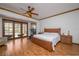 Spacious bedroom with a wood bed frame, neutral bedding and ceiling fan at 725 Bear Creek Cir, Winter Springs, FL 32708