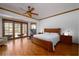 Spacious bedroom with a wood bed frame, neutral bedding and ceiling fan at 725 Bear Creek Cir, Winter Springs, FL 32708