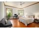 This bedroom features a ceiling fan, wood trim, and a bay window, flooding the space with natural light at 725 Bear Creek Cir, Winter Springs, FL 32708