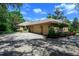 Brick home exterior with a three-car garage and spacious driveway at 725 Bear Creek Cir, Winter Springs, FL 32708