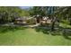Brick home with lush green lawn, mature trees, and well-maintained landscaping, offering curb appeal at 725 Bear Creek Cir, Winter Springs, FL 32708