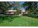 Charming brick home with mature trees, manicured landscaping, and a welcoming front entrance at 725 Bear Creek Cir, Winter Springs, FL 32708
